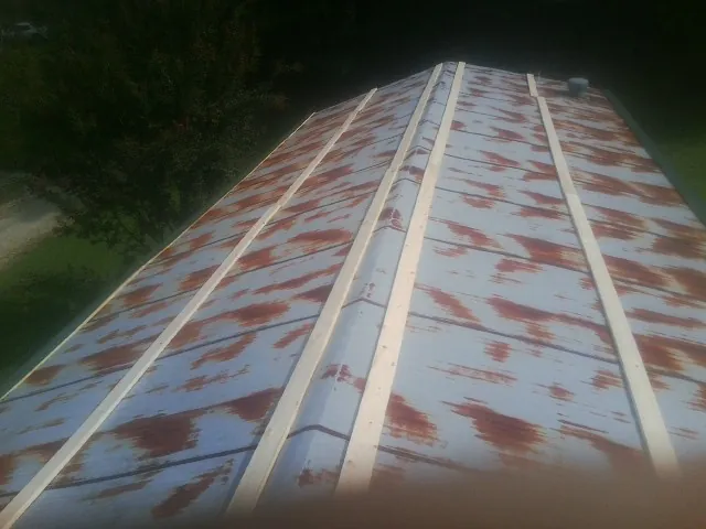 Rusted metal roof panels with new wood purlins before replacement — Storm Damage Roof Repair in Isleton by Roofing Brothers