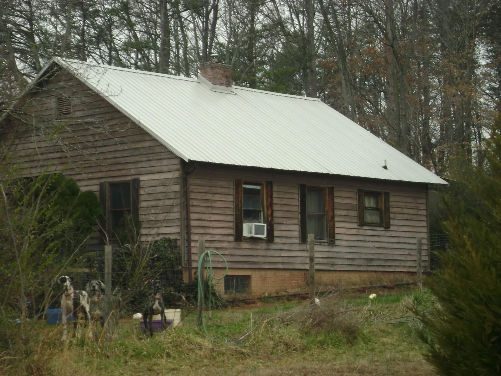 White metal roof on an old wood sided farmhouse, from a Metal Roof Installation job in Isleton